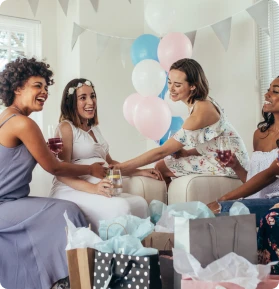 Group of women at a festive cake and drinks at a baby shower